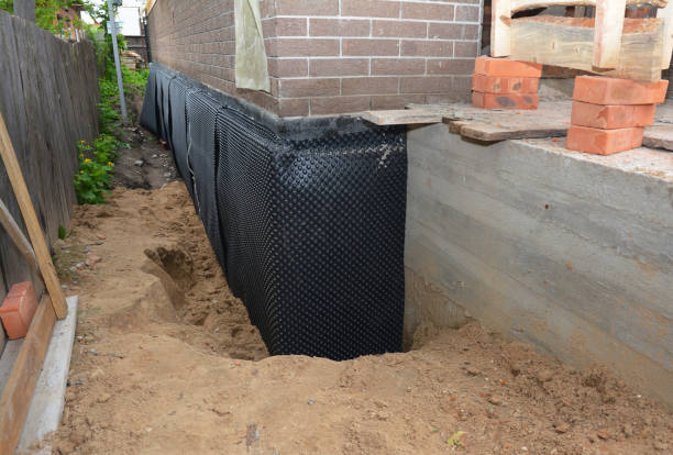 Happy homeowners after waterproofing job in Quinton
